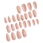 Extensiones de uñas decorativas con punta francesa y detalles de gemas