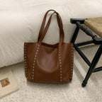 Bolso tote de piel con tachuelas